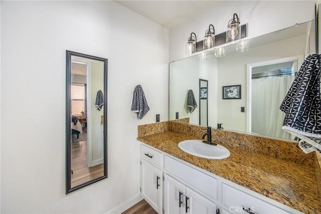 1388 E 39th St, San Bernardino, CA 92404 - bathroom with vanity, baseboards, and wood finished floors