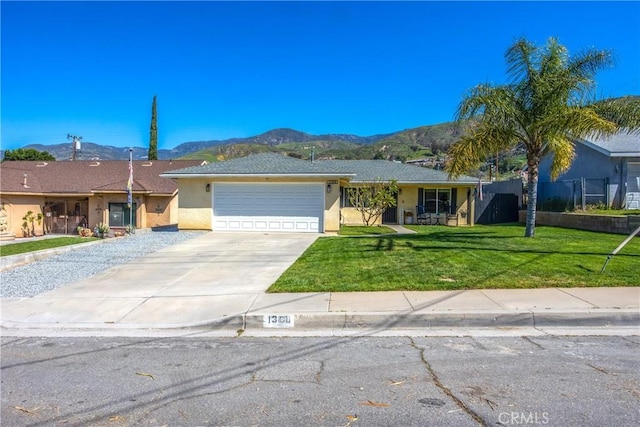 1388 E 39th St, San Bernardino, CA 92404 - ranch-style home with a mountain view, stucco siding, an attached garage, concrete driveway, and a front lawn