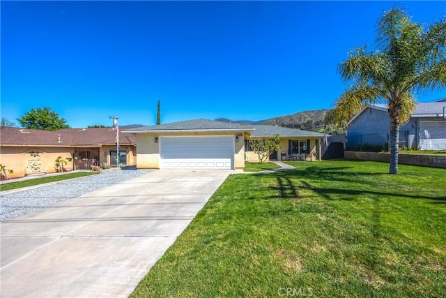 1388 E 39th St, San Bernardino, CA 92404 - ranch-style home with stucco siding, an attached garage, concrete driveway, and a mountain view