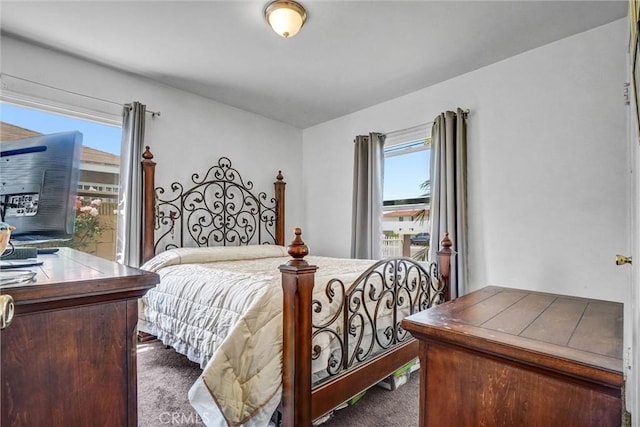 bedroom featuring dark carpet