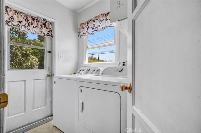 clothes washing area featuring separate washer and dryer