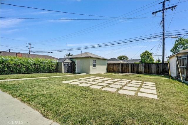 view of yard featuring an outdoor structure and a storage unit