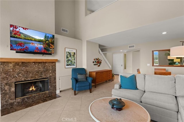 27345 Via Capri, San Juan Capistrano, CA 92675 - living room featuring tile patterned flooring, a premium fireplace, stairway, and a towering ceiling
