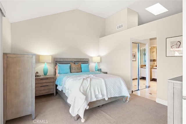 27345 Via Capri, San Juan Capistrano, CA 92675 - bedroom with light colored carpet, vaulted ceiling, a skylight, and connected bathroom