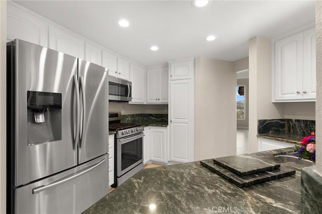 27345 Via Capri, San Juan Capistrano, CA 92675 - kitchen featuring appliances with stainless steel finishes, white cabinetry, dark stone countertops, recessed lighting, and light wood finished floors