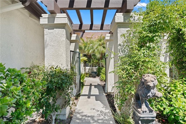 27345 Via Capri, San Juan Capistrano, CA 92675 - view of exterior entry with stucco siding and a pergola