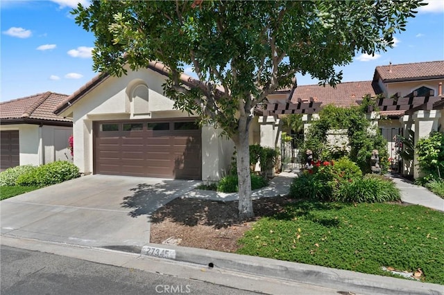 27345 Via Capri, San Juan Capistrano, CA 92675 - view of front of home featuring an attached garage, stucco siding, concrete driveway, and a tile roof