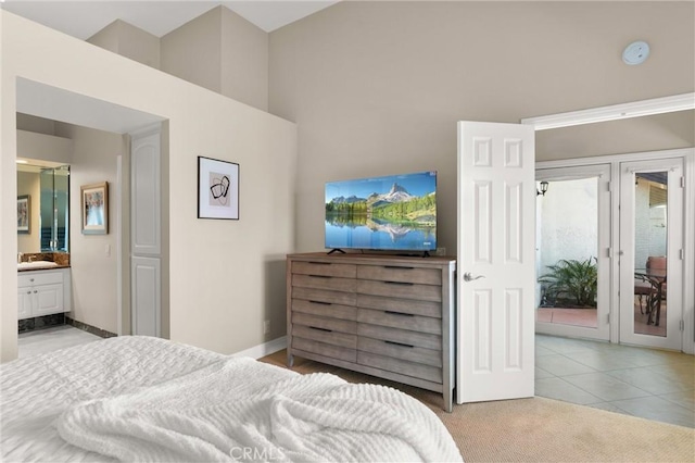 27345 Via Capri, San Juan Capistrano, CA 92675 - carpeted bedroom featuring a high ceiling, french doors, ensuite bathroom, tile patterned floors, and baseboards