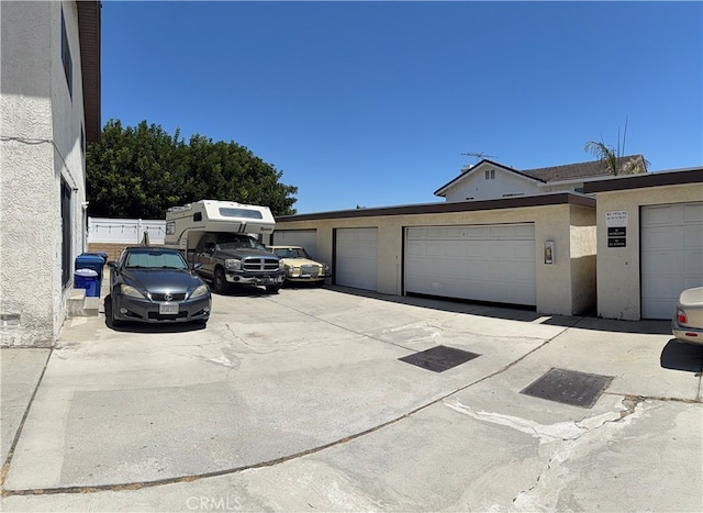 view of property exterior with community garages and stucco siding