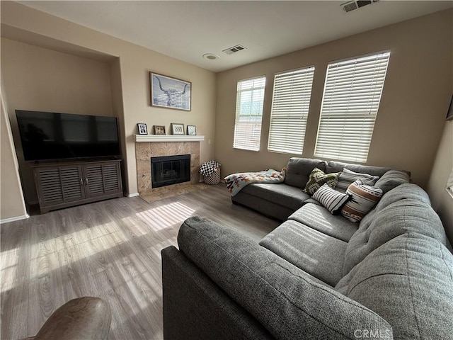 28282 Socorro St Unit 100, Murrieta, CA 92563 - living room with wood finished floors, a tiled fireplace, and baseboards