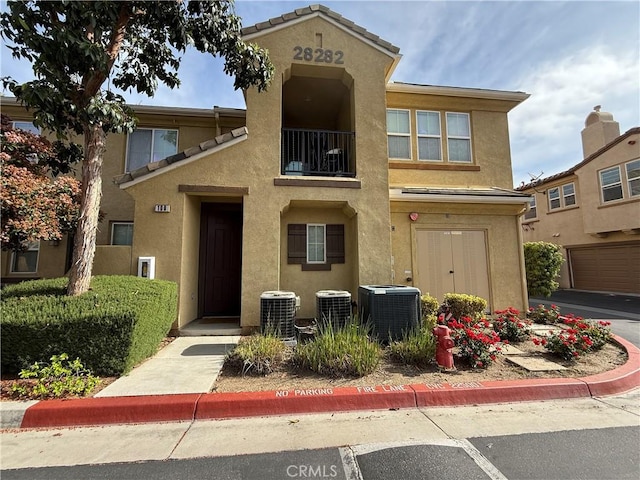 28282 Socorro St Unit 100, Murrieta, CA 92563 - townhome / multi-family property with central air condition unit and stucco siding