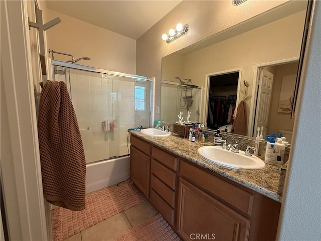 28282 Socorro St Unit 100, Murrieta, CA 92563 - bathroom featuring tile patterned floors, double vanity, a walk in closet, and shower / bath combination with glass door