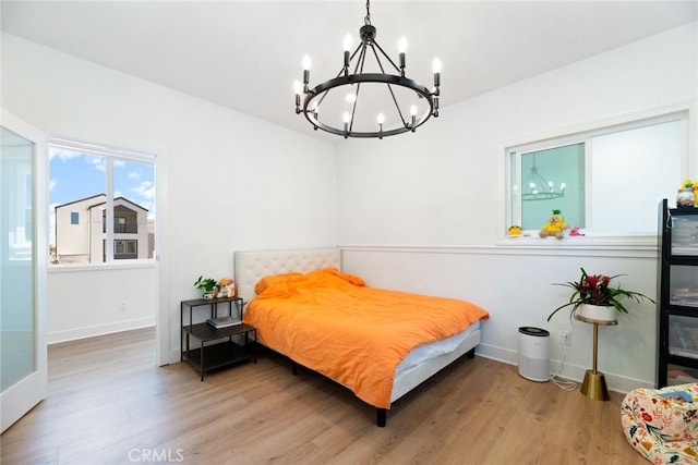 188 Merit, Irvine, CA 92618 - bedroom with a chandelier, wood finished floors, and baseboards