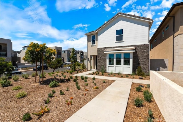 188 Merit, Irvine, CA 92618 - view of front facade with a residential view and stone siding