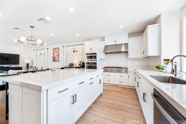 188 Merit, Irvine, CA 92618 - kitchen featuring under cabinet range hood, stainless steel appliances, a sink, white cabinets, and recessed lighting