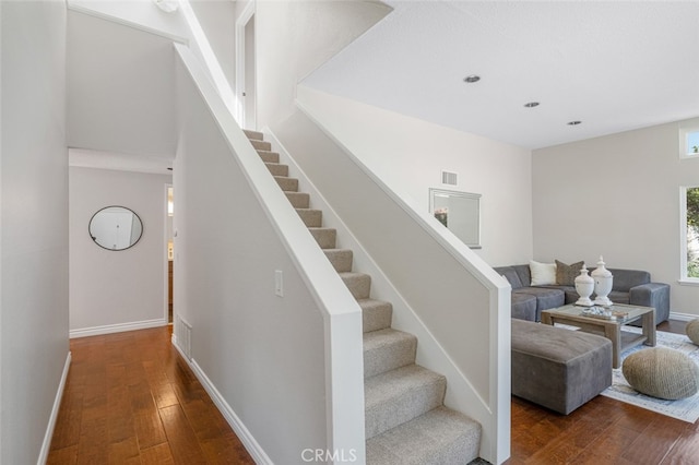 stairs with hardwood / wood-style floors, baseboards, and recessed lighting