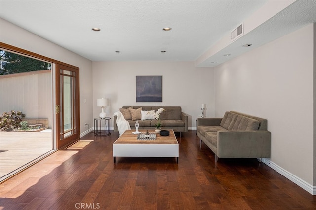 living room with hardwood / wood-style floors, recessed lighting, and baseboards