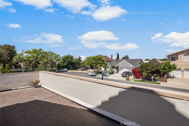 view of road with a residential view and street lights