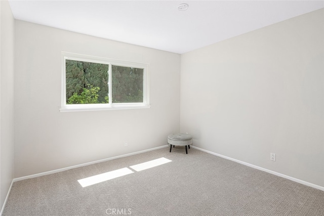 empty room with carpet flooring and baseboards