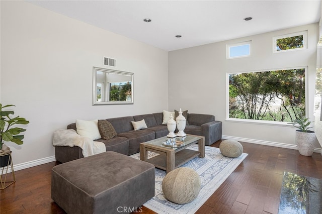 living area featuring baseboards, dark wood finished floors, and recessed lighting