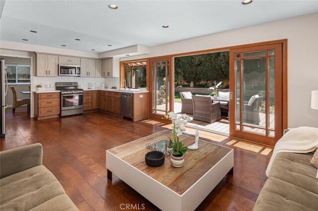 living area featuring dark wood-style flooring, recessed lighting, and plenty of natural light