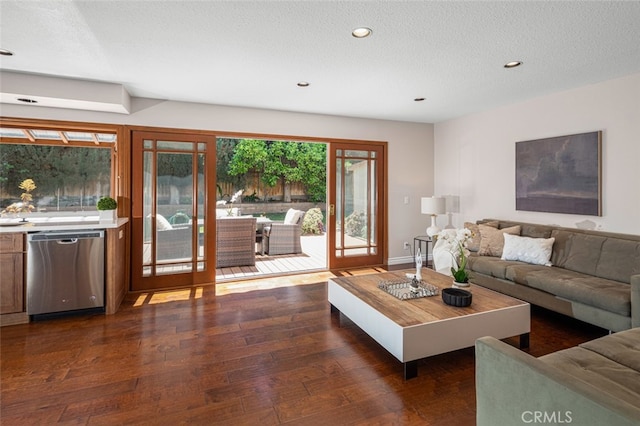living area featuring dark wood-style floors, recessed lighting, a textured ceiling, and baseboards