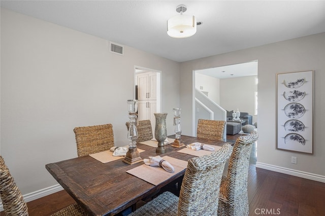 dining space with stairway, wood-type flooring, and baseboards