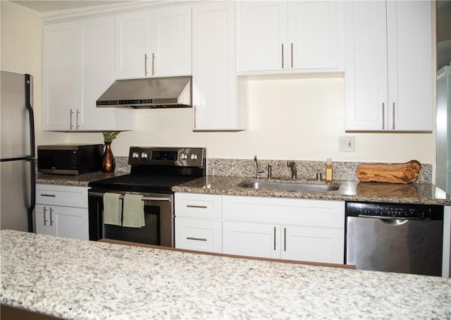 2852 Sawtelle Blvd Unit 41, Los Angeles, CA 90064 - kitchen with appliances with stainless steel finishes, under cabinet range hood, a sink, light stone countertops, and white cabinets