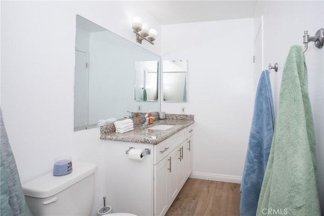 2852 Sawtelle Blvd Unit 41, Los Angeles, CA 90064 - bathroom featuring wood finished floors, vanity, toilet, and baseboards
