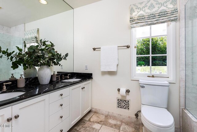 741 Burleigh Dr, Pasadena, CA 91105 - bathroom featuring toilet, baseboards, double vanity, a shower, and stone finish floors