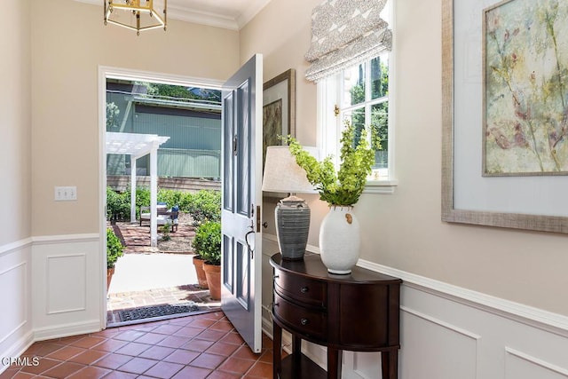 741 Burleigh Dr, Pasadena, CA 91105 - doorway with crown molding, wainscoting, dark tile patterned floors, and a decorative wall