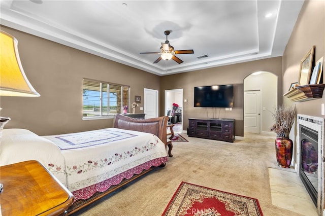 38792 Comanche Point Rd, Arvin, CA 93203 - bedroom featuring a tray ceiling, arched walkways, carpet, and a ceiling fan