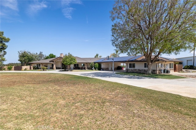 38792 Comanche Point Rd, Arvin, CA 93203 - ranch-style home featuring concrete driveway, an attached carport, solar panels, and a front lawn