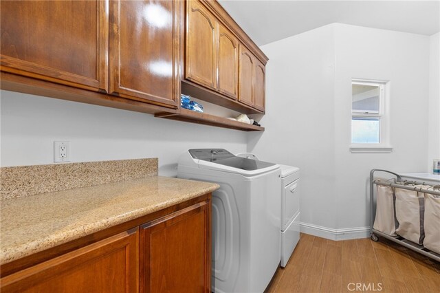 38792 Comanche Point Rd, Arvin, CA 93203 - laundry area featuring washing machine and dryer, light wood-style floors, baseboards, and cabinet space
