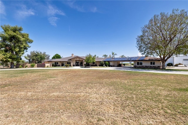 38792 Comanche Point Rd, Arvin, CA 93203 - ranch-style house with concrete driveway, solar panels, and a carport