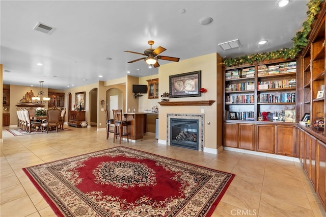 38792 Comanche Point Rd, Arvin, CA 93203 - living area featuring arched walkways, a fireplace, light tile patterned floors, a ceiling fan, and recessed lighting