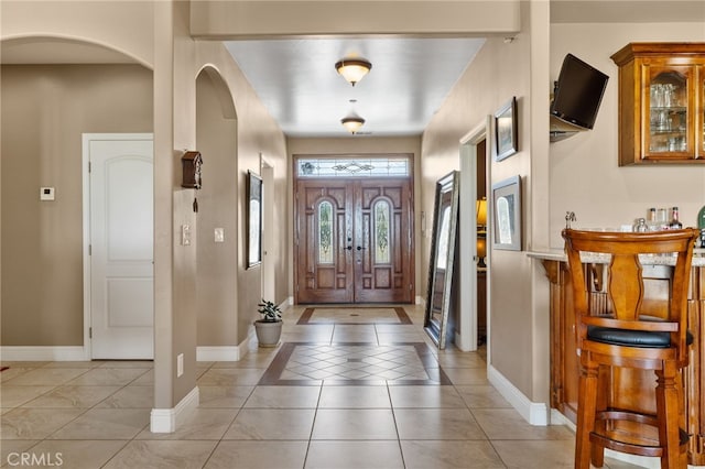 38792 Comanche Point Rd, Arvin, CA 93203 - entrance foyer with baseboards, arched walkways, and light tile patterned floors