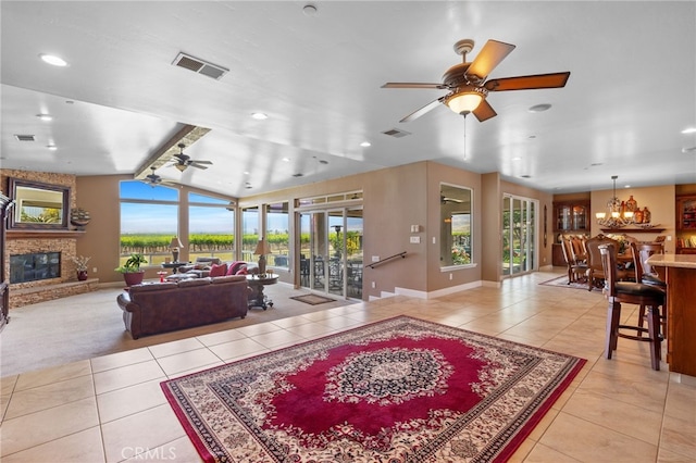 38792 Comanche Point Rd, Arvin, CA 93203 - living area with a ceiling fan, light tile patterned floors, a glass covered fireplace, healthy amount of natural light, and vaulted ceiling
