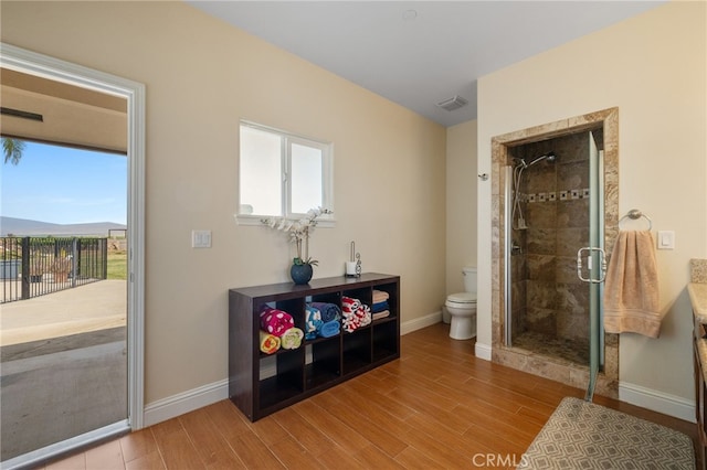 38792 Comanche Point Rd, Arvin, CA 93203 - bathroom featuring baseboards, a stall shower, toilet, and wood finished floors
