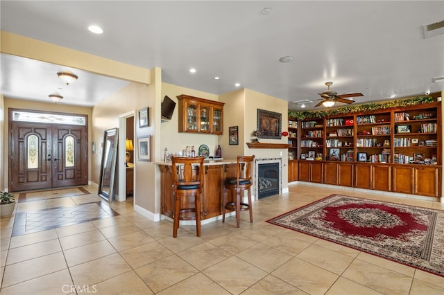 38792 Comanche Point Rd, Arvin, CA 93203 - entryway with light tile patterned floors, ceiling fan, recessed lighting, baseboards, and a fireplace