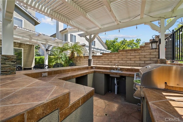 28456 Calex Dr, Valencia, CA 91354 - view of patio featuring an outdoor kitchen, a pergola, grilling area, and a sink