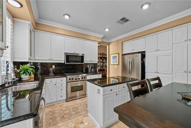 28456 Calex Dr, Valencia, CA 91354 - kitchen featuring stainless steel appliances, a sink, white cabinetry, ornamental molding, and recessed lighting