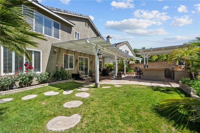 28456 Calex Dr, Valencia, CA 91354 - back of house with a yard, a pergola, stucco siding, and a patio