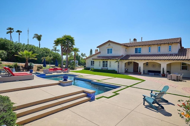 view of pool with an outdoor living space, a patio area, and a pool with connected hot tub