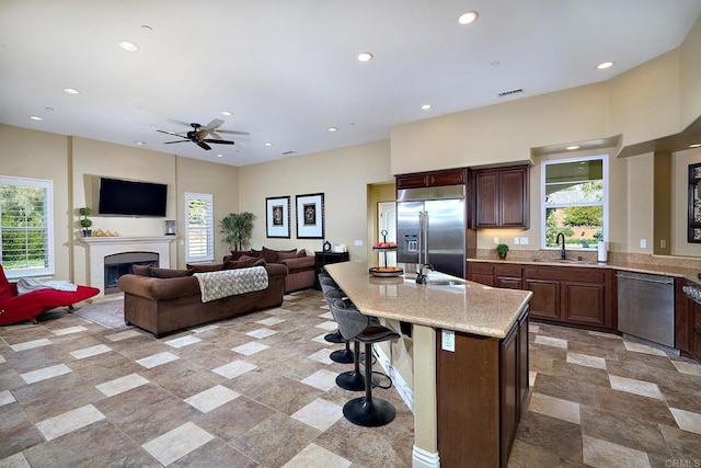 kitchen with appliances with stainless steel finishes, a sink, healthy amount of natural light, and recessed lighting