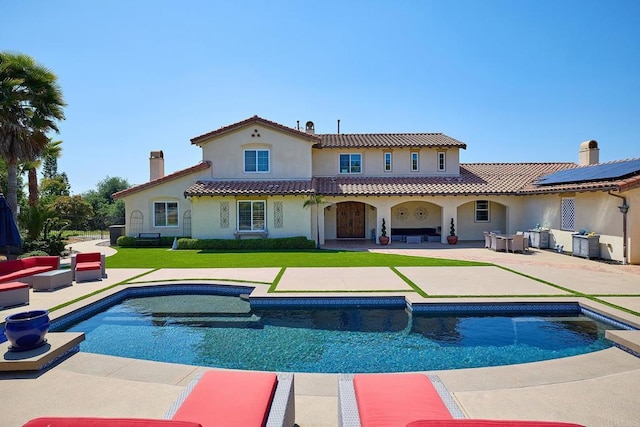 back of property featuring a patio, stucco siding, an outdoor living space, and a yard