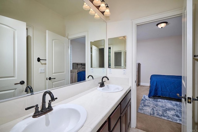 full bathroom featuring double vanity and ensuite bathroom
