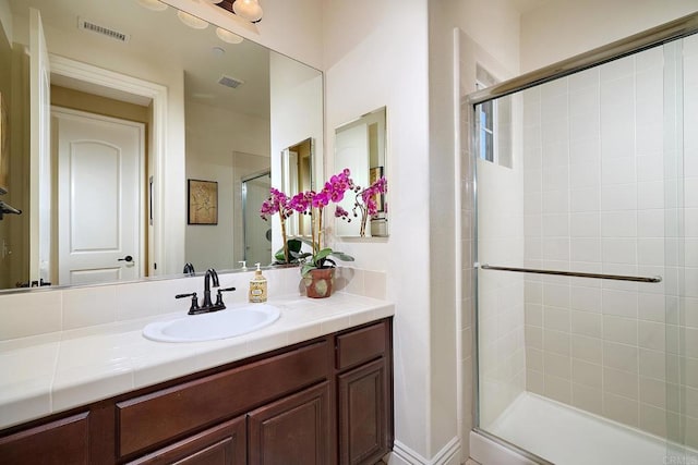 full bathroom featuring a stall shower and vanity