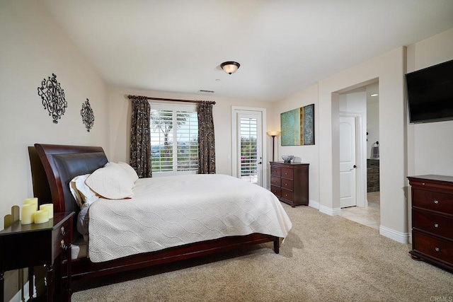 bedroom with light colored carpet, baseboards, and access to exterior