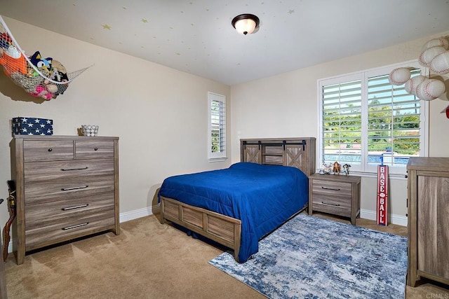 carpeted bedroom featuring baseboards